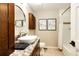 Updated bathroom with modern fixtures, granite countertops, and a shower-tub combo at 10601 E Crestline Ave, Englewood, CO 80111