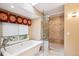 Elegant bathroom showcasing a soaking tub, a glass shower, and modern fixtures at 10601 E Crestline Ave, Englewood, CO 80111