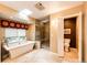 Bright bathroom with a soaking tub, glass-enclosed shower, and a separate toilet room at 10601 E Crestline Ave, Englewood, CO 80111