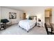 Bedroom featuring an abstract art piece, neutral carpet, and a closet at 10601 E Crestline Ave, Englewood, CO 80111
