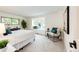 Well-lit bedroom features a large window, neutral carpet, and calming decor, creating a peaceful and inviting space at 10601 E Crestline Ave, Englewood, CO 80111