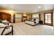 Expansive bedroom featuring a sitting area, neutral carpet, and natural lighting at 10601 E Crestline Ave, Englewood, CO 80111