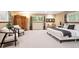 Spacious bedroom with seating area, a large bed, and views of the backyard and nature at 10601 E Crestline Ave, Englewood, CO 80111