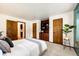 Bedroom featuring built-in shelving and storage, neutral carpet, and a plant at 10601 E Crestline Ave, Englewood, CO 80111