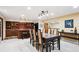 Basement dining area leading to the kitchen, offering ample seating and views of other living spaces at 10601 E Crestline Ave, Englewood, CO 80111