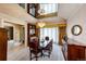 Elegant dining room with mirrored ceiling, chandelier, and classic wooden furniture for memorable dining experiences at 10601 E Crestline Ave, Englewood, CO 80111