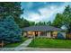 Charming single-story brick home with a beautifully landscaped front yard and inviting walkway to the front door at 10601 E Crestline Ave, Englewood, CO 80111