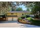 Two-car garage featuring an extended driveway with lush landscaping in the backyard at 10601 E Crestline Ave, Englewood, CO 80111