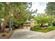 Two story home featuring mature trees, a long driveway, and a two car garage at 10601 E Crestline Ave, Englewood, CO 80111