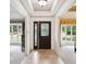 Inviting foyer featuring neutral tile flooring and a modern front door with sidelight at 10601 E Crestline Ave, Englewood, CO 80111