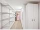 Finished basement hallway with storage and shelving and bright neutral decor at 10601 E Crestline Ave, Englewood, CO 80111