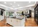 Spacious open kitchen with double islands, hardwood floors, and a large built-in cabinet at 10601 E Crestline Ave, Englewood, CO 80111