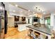 Spacious kitchen features hardwood floors, large islands, and modern lighting at 10601 E Crestline Ave, Englewood, CO 80111