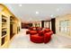 Cozy living room featuring a round sofa and ottoman, plus an open layout with bar and kitchen in background at 10601 E Crestline Ave, Englewood, CO 80111