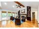 Inviting living room with hardwood floors, vaulted ceiling, fireplace, and built-in bookshelves for relaxation at 10601 E Crestline Ave, Englewood, CO 80111