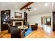 Warm and inviting living room with fireplace, hardwood floors, and comfortable seating arrangement for cozy gatherings at 10601 E Crestline Ave, Englewood, CO 80111