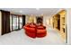 Basement living room with a cozy fireplace and built-in shelving units at 10601 E Crestline Ave, Englewood, CO 80111