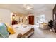 Bright main bedroom with a ceiling fan, neutral carpet, and French doors to a patio at 10601 E Crestline Ave, Englewood, CO 80111