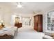 Large primary bedroom with neutral tones, natural light, and a walk-out to the patio at 10601 E Crestline Ave, Englewood, CO 80111
