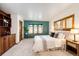 Charming bedroom with built-ins, natural light, and a serene, comfortable atmosphere at 10601 E Crestline Ave, Englewood, CO 80111