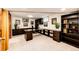 A home office features custom desk, cabinetry, and storage to maximize the use of the space at 10601 E Crestline Ave, Englewood, CO 80111