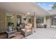 Inviting outdoor patio featuring cozy seating, a striped rug, and views of the lush yard at 10601 E Crestline Ave, Englewood, CO 80111