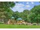 Community playground with green canopies, slides, and various climbing structures at 10601 E Crestline Ave, Englewood, CO 80111