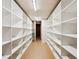 Large storage area with lots of white shelving and ample room for organization at 10601 E Crestline Ave, Englewood, CO 80111