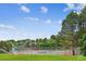 Community tennis court with net, green trees, and well-maintained grass at 10601 E Crestline Ave, Englewood, CO 80111