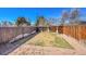 Fenced backyard with patio and grass at 3209 N Olive St, Denver, CO 80207