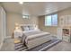 Cozy bedroom with plush gray carpet, sleek white furniture and a comfortable bed at 3209 N Olive St, Denver, CO 80207