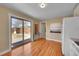 Bright open kitchen with hardwood floors, granite countertops, and sliding door access to the backyard at 3209 N Olive St, Denver, CO 80207