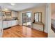 Well-lit kitchen with hardwood floors, white cabinets, granite counters, and a sliding door to the backyard at 3209 N Olive St, Denver, CO 80207