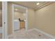 A view into the laundry room with washer and dryer, plus storage at 3209 N Olive St, Denver, CO 80207