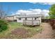 Fenced backyard featuring a wooden deck, grass, and partial fencing at 18830 E 16Th Pl, Aurora, CO 80011