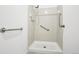 Tiled bathroom with safety grab bars and showerhead at 18830 E 16Th Pl, Aurora, CO 80011