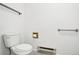 Bathroom features white walls, toilet, and grab bars at 18830 E 16Th Pl, Aurora, CO 80011