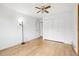 This bedroom features hardwood floors, a ceiling fan, and a closet with bi-fold doors at 18830 E 16Th Pl, Aurora, CO 80011