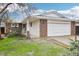 Charming single-story home featuring a brick and white painted exterior and an attached two-car garage at 18830 E 16Th Pl, Aurora, CO 80011