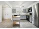 Well-lit kitchen featuring tile flooring, gray cabinets, modern appliances, and an island at 18830 E 16Th Pl, Aurora, CO 80011