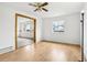 The living room features hardwood floors, white walls, a large window, and views of the front yard at 18830 E 16Th Pl, Aurora, CO 80011