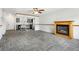 Spacious living room boasting tile flooring, a fireplace, and glass paneled doors into the kitchen at 18830 E 16Th Pl, Aurora, CO 80011