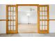 Bright living room featuring French doors, neutral walls, and wood-look flooring at 18830 E 16Th Pl, Aurora, CO 80011