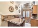 Bar area with decorative stone wall, tile countertops, and wooden cabinets at 3080 Madison Ln, Broomfield, CO 80023