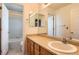 Bathroom with a vanity, an oval sink, and a shower-tub combo with tiled walls at 3080 Madison Ln, Broomfield, CO 80023