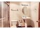 Bathroom featuring a pedestal sink, toilet, and shower with marble tiled walls at 3080 Madison Ln, Broomfield, CO 80023