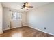 Bedroom with hardwood floors, a ceiling fan, and a window with blinds and curtains at 3080 Madison Ln, Broomfield, CO 80023