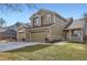 Charming two-story home featuring a three car garage, brick accents and well maintained lawn at 3080 Madison Ln, Broomfield, CO 80023