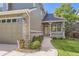 Delightful home with a charming covered porch, beautiful landscaping, and a two-car garage at 3080 Madison Ln, Broomfield, CO 80023
