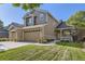 Charming two-story home featuring a well-manicured lawn, brick accents, and an inviting covered porch at 3080 Madison Ln, Broomfield, CO 80023